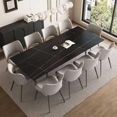 a dining room table with white chairs around it