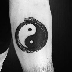 a black and white photo of a tattoo with a yin - yang symbol on it