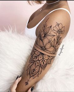 a woman with a flower tattoo on her arm