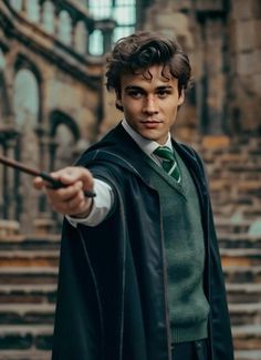 a young man dressed in harry potter costume pointing at the camera with his right hand