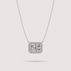 Elevate your style with this exquisite necklace crafted from 14K white gold. The centerpiece features a radiant cut solitaire lab diamond encircled by a dazzling halo of smaller lab diamonds, creating a mesmerizing cluster effect. With its timeless elegance and sophisticated design, this necklace is sure to become a cherished piece in your jewelry collection. ✤𝐃𝐢𝐚𝐦𝐨𝐧𝐝 𝐃𝐞𝐭𝐚𝐢𝐥𝐬 Color: F Clarity: VS1 Shape: Radiant Cut Carat Weight: 1 CT Approx. (5*7 MM) Type: Lab Diamond ✤ 𝐒𝐢𝐝𝐞 𝐃𝐢𝐚𝐦𝐨𝐧𝐝 𝐃𝐞𝐭𝐚𝐢𝐥𝐬 Color: F Clarity: VS1 Shape: Round Carat Weight: 0.12 CT Type: Lab Diamonds ✤Metal 𝐃𝐞𝐭𝐚𝐢𝐥𝐬 Metal Purity: Solid 14K Gold Metal Tone: Yellow, White, Rose Stamp/Hallmark: Yes Jewelry Certificate: Free of Cost with Listed Design Chain Length: 16″ inch White Gold Solitaire Necklace With Radiant Cut Diamond, Radiant Cut Solitaire Necklace In White Gold, Cushion Cut Cubic Zirconia Fine Jewelry Necklace, Cushion Cut Cubic Zirconia Fine Necklace, Diamond White Solitaire Necklace With Radiant Cut, Formal Radiant Cut Cubic Zirconia Solitaire Necklace, Formal Radiant Cut Solitaire Necklace With Cubic Zirconia, Luxury Radiant Cut Cubic Zirconia Necklaces, Classic Diamond Halo Necklace