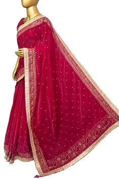 Appear stunningly this party season with designer velvets exclusively available with us. Made with soft velvet fabric, it features intricate zari embroidery all over, created using a special machine. The lace border is adorned with delicate mirrorwork, and the pallu has tassels hanging from it. Elevate your ethnic wardrobe with this unique and luxurious saree. Color: A shade of magenta color Technique: An enriching work of zari embroidery with a lace border with mirror work and tassels on the pa Red Velvet Traditional Wear With Dupatta, Velvet Saree For Wedding, Elegant Traditional Wear With Resham Embroidery On Velvet, Velvet Traditional Wear With Resham Embroidery For Wedding, Velvet Saree With Resham Embroidery For Reception, Velvet Traditional Wedding Wear, Wedding Traditional Velvet Wear With Dupatta, Party Velvet Saree With Resham Embroidery, Velvet Dupatta For Wedding