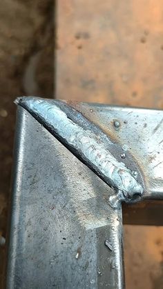 a piece of metal sitting on top of a wooden table