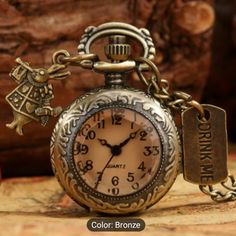 an antique style pocket watch with charms attached to it