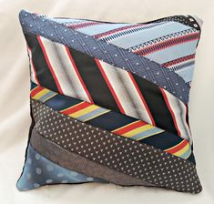 a blue pillow with different colored ties on it