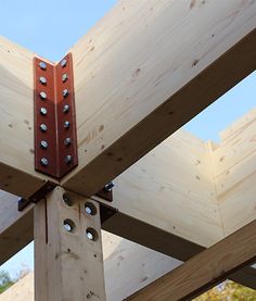 a wooden structure with metal rivets on it