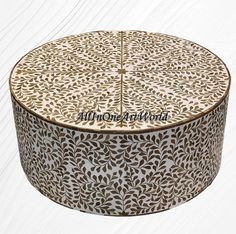 a round box with an intricate design on it