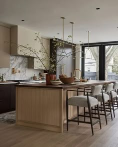 a kitchen filled with lots of counter top space next to a dining room table and chairs