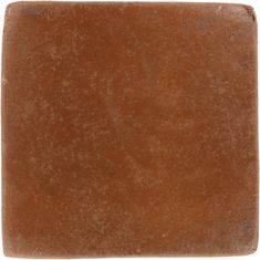 a brown square shaped tile on a white background