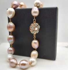 One of a kind pearl necklace.  Vintage pearl necklace totally handmade with chunky oval shaped cultured pearls in pink/gold shades and approximate dimensions 1.5-1.8 cm / 0.59-0.70 inches. The beautiful pearls are tied on a rose gold plated silver 925o rosary chain ending to a vintage flower clasp with keshi pearls and  2cm / 0.78 inches diameter. The length of the pearl necklace is non adjustable 43 cm/16.92 inches. A gift to impress this unique pearl necklace is breathtaking. Ideal as an Anniv Rose Gold Single Strand Pearl Necklace, Elegant Handmade Rose Gold Pearl Necklace, Unique Pearl Necklace, Vintage Pearl Necklace, Gold Shades, Pearl Clasp, Pink Pearl Necklace, Pearl Necklace Vintage, Gold Pearl Necklace