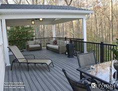 a covered deck with chairs and couches on it