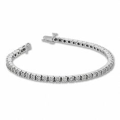 A classic look just for her, this 1/2 ct. t.w. diamond tennis bracelet in sterling silver complements every look and every occasion. Fashioned in sleek sterling silver Round diamonds - each artfully set to enhance size and sparkle - line this timeless tyle. Look great solo or layered with her other favorite bracelets Captivating with 1/2 ct. t.w. of diamonds This 7.25-inch bracelet secures with a tongue and groove clasp. Classic Sterling Silver Bracelet In Diamond White, Classic Diamond White Sterling Silver Bracelet, Classic Silver Channel Set Diamond Bracelet, Classic Diamond Bracelet With Channel Set, Timeless Channel Set Tennis Bracelet For Anniversary, Classic Sterling Silver Bracelet With Prong Setting, Classic Channel Set Diamond Bracelet, Classic Sterling Silver Tennis Bracelet, Classic White Diamond Bracelet With Accents