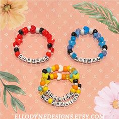 three bracelets with words on them and flowers