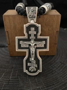 "Silver cross with ebony wood. Art. 0178 ✔️925 silver with blackening + ebony wood ✔️Size 80/39.6 mm ✔️Weight 54 grams ✔️The cross depicts: 🔘Jesus Christ 🔘Mother of God 🔘Nicholas the Wonderworker 🔘Vladimir the Great 🔘Panteleimon the Healer 🔘Guardian Angel ✔️On the end is the complete prayer \"Our Father\" ✔️Possible production in: 🟡Gold 14K or 18K (red, yellow, white) 🌕24K gold plated sterling silver 🔘Silver with blackening or rhodium Need more information? If you have any questions please don't hesitate to contact us!" Engraved Black Cross Necklace As Gift, Black Engraved Cross Jewelry, Gift Black Engraved Cross Necklace, Black Engraved Cross Necklace Gift, Black Engraved Pendant Cross Necklace, Engraved Black Cross Necklace For Gift, Spiritual Black Sterling Silver Cross Necklace, Black Crucifix Necklace Engraved, Black Spiritual Cross Jewelry