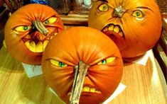 three pumpkins that have been carved to look like faces