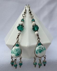 These earrings are made with clear and sparkling teal, white, and silver beads.   They accent a teal and white bead.  There are 3 silver and clear teal drops at the base of each earring.   These earrings measure at almost 3 1/2 inches long.  They are made on silver French wires, but can be changed to silver posts at no extra cost to you if you would like; just message me on the message board. There is no shipping in the contiguous 48 states.  Thank you for visiting my shop! French Wire, White Jewelry, Beaded Dangle Earrings, Message Board, Etsy Earrings Dangle, Beaded Dangles, White Beads, White Silver, Silver Beads