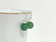 A Pair of Handcrafted short dangle/drop earrings with perfect round genuine green aventurine. The finish of the finely made earrings delivers an elegant and minimalist feel. One of a kind earrings suitable for any occasion. Perfect gift for women, mothers, and girls! Length: 2.5cm (including Ear Wire) Materials: -925 sterling silver -aventurine 🌟All of our products are 100% handmade in Canada and made from our own original design. ---------------------------- 🌟Maintenance - To prevent tarnishing, place the item in a zipped bag and box when not using. 🌟Follow us on Instagram and tag us to be featured : @katecraftsxx 🌟Please check out more design in our shop: https://www.etsy.com/ca/shop/Katelifestyle ---------------------------- Please feel free to contact me with any questions! Thank y Aventurine Drop Earrings For Gift, Aventurine Dangle Earrings For Gift, Aventurine Earrings, Minimalist Earrings Silver, Simple Silver Earrings, Earrings Round, Earrings Simple, Gemstone Beaded Bracelets, Earrings Minimalist