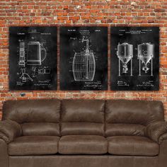 three framed art prints on a brick wall with a couch and chair in front of it