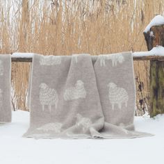 two blankets sitting on top of snow covered ground