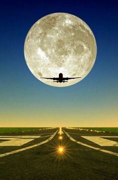 an airplane is flying in front of the moon