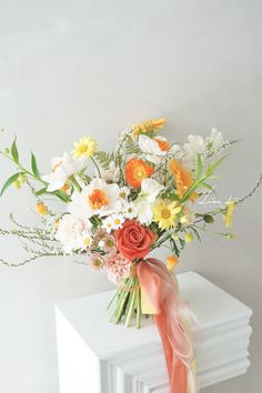 a bouquet of flowers sitting on top of a radiator