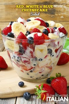 red, white and blue cheesecake salad in a bowl with strawberries on the side