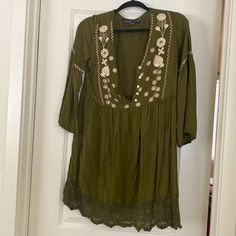 Size: M Color: Olive Green Material: Rayon Details: Never Worn Bohemian V-neck Blouse For Day Out, Spring Folk Style V-neck Peasant Top, Bohemian V-neck Rayon Peasant Top, Rayon Tunic For Spring, Green Boho Print Summer Blouse, Casual Green Blouse With Boho Print, Green Bohemian Peasant Top, Flowy Fit, Green Bohemian Flowy Peasant Top, Bohemian Green V-neck Tunic