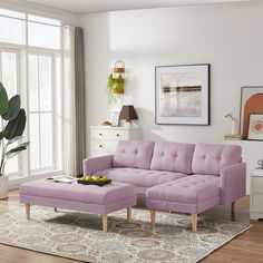 a living room with a purple couch and coffee table in front of a large window