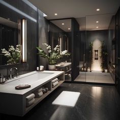 a large bathroom with two sinks, mirrors and plants in vases on the counter