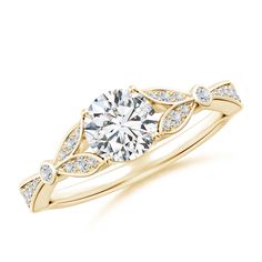 a yellow gold engagement ring with an oval cut diamond in the center and side stones