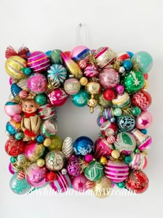 an ornament wreath with ornaments hanging from it