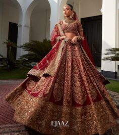 a woman in a red and gold bridal gown