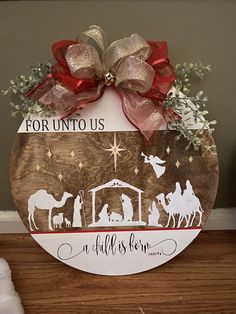 a wooden sign with the birth of jesus and three wise men on it that says for unto us