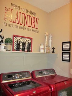 a red washer and dryer sitting next to each other in a laundry room