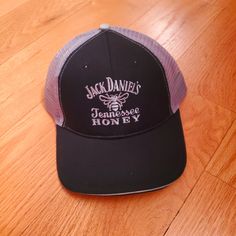 a jack daniels hat sitting on top of a wooden floor