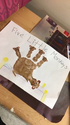 a child's handprint is on top of a paper with the words five little monkeys