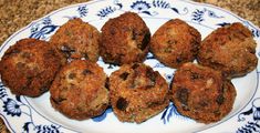 a white and blue plate topped with muffins on top of a countertop