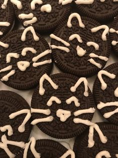 oreo cookies with white icing are arranged in a pattern on a table top