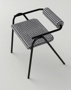 a black and white chair sitting on top of a table