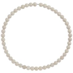 a white beaded necklace on a white background