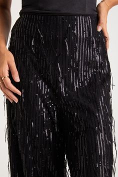 The most glamorous way to elevate any late-night look is with the Lulus Shimmery Aura Black Sequin Fringe High-Rise Wide-Leg Pants! Dazzling fringe-y sequin details adorn these mesh pants that feature a flattering high-rise fit and trendy wide pant legs that fall to full-length hems. Hidden side zipper/clasp. Pair with an equally shiny pair of heels for a truly stunning look! Fit: This garment fits true to size. Length: Ankle length. Size medium Inseam: 29.00 Front Rise: 12.50 Waist: Fitted - ve Elegant Sequined Bottoms For Gala, Glamorous Holiday Party Bottoms, Sequin Bottoms For Date Night And Holidays, Glamorous Holiday Evening Bottoms, Glamorous Festive Party Bottoms, Festive Party Bottoms With Sequins, Glamorous Holiday Festive Bottoms, Festive Glamorous Party Bottoms, Chic Bottoms For Date Night And Holiday Season