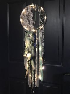 a light up dream catcher hanging from a door