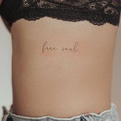 a woman's stomach with the word free soul written on it in cursive font