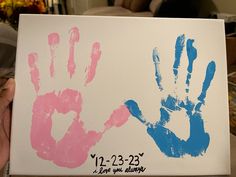 two handprints are displayed on a canvas