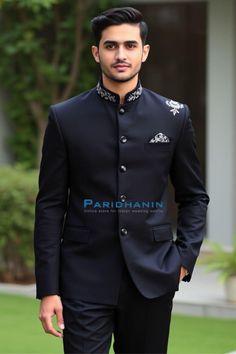 This striking black Indo-Western suit features intricate embroidery on the collar and shoulder, giving it a regal touch. Designed for modern grooms or formal events, the suit combines elegance and sophistication with a sleek silhouette. Perfect for those who want to stand out with understated luxury. Nehru suit 2 Pc (Jacket, Pants). Made in Black color pure polyester fabric. All sizes shown are US Sizes for men Care Instructions : Dry Clean Only Designer Black Tuxedo For Groom, Traditional Black Tuxedo For Groom, Black Tuxedo For Groom Festive Occasion, Traditional Black Groom Tuxedo, Designer Black Nehru Jacket For Ceremonial Occasions, Festive Black Tuxedo For Groom, Traditional Tailored Bandhgala For Reception, Designer Nehru Jacket With Resham Embroidery For Formal Events, Black Dabka Wedding Suit