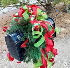 a mailbox decorated with green and red ribbons