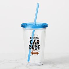 a plastic cup with a blue lid and a straw in front of it that says little car dude