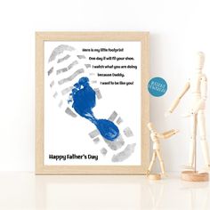 a father's day card with a blue handprint on it next to a wooden doll