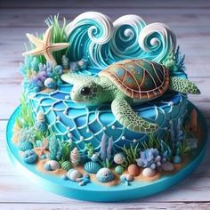 a cake decorated with sea animals and seashells on top of a blue plate