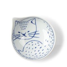 a blue and white bowl with a cat on it